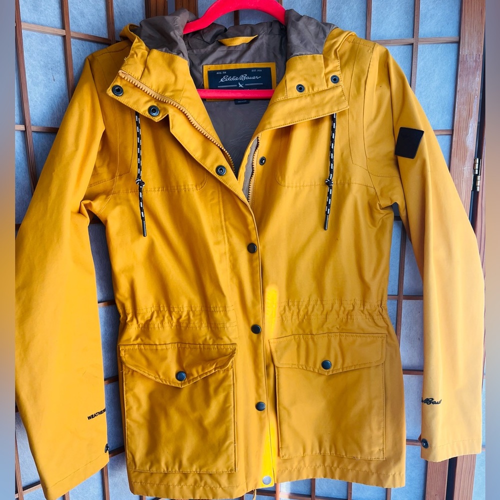 Eddie Bauer yellow windbreaker/raincoat, lightly worn, light markings.